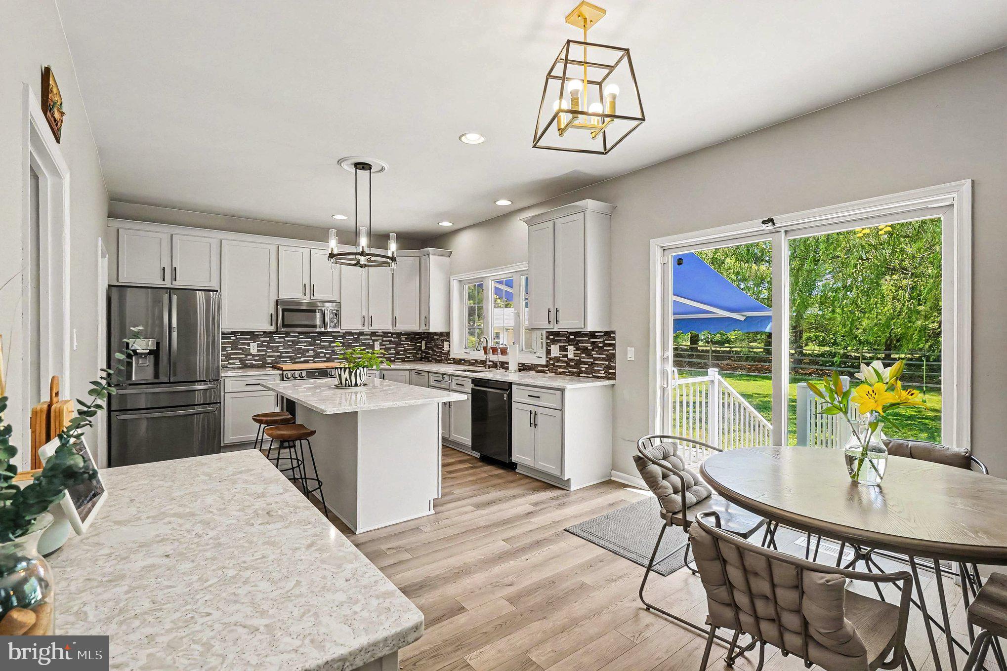 64 Open Meadow Court Elkton, MD 21921 - Photo 18 of 57 a kitchen with a table chairs refrigerator and microwave