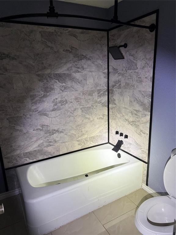4601 Elm Ridge Lane Garland, TX 75044 - Photo 12 of 21 Bathtub with patterned wall tiling, matte black shower head, and coordinating tub filler