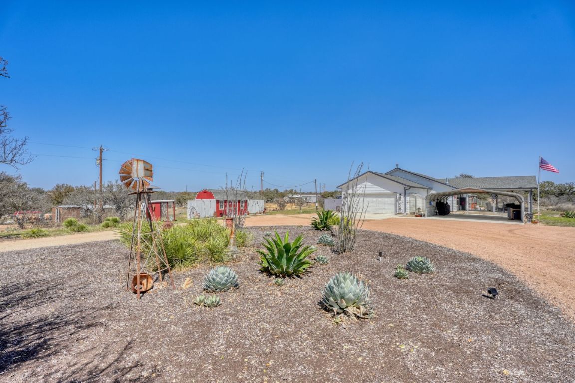 a view of a house with a yard and sitting area