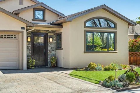 a front view of a house with garden