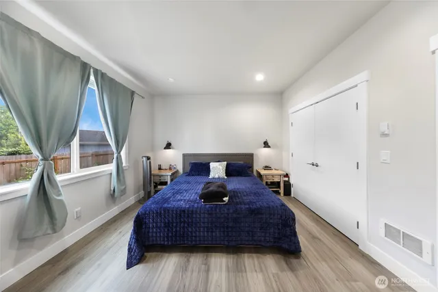 a living room with a bed and a large window