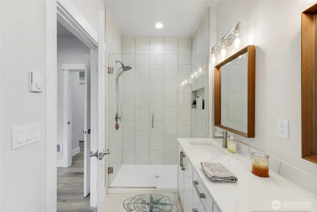 a bathroom with a sink a toilet and shower