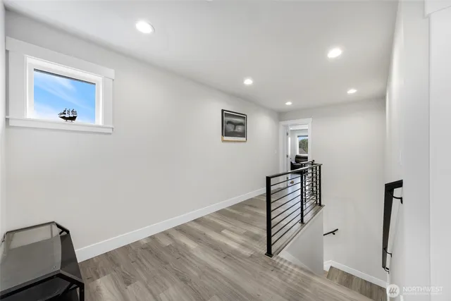 a view of room with stairs and wooden floor