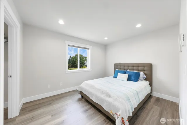 a bedroom with a large bed and a window