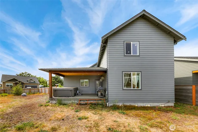 a view of a house with backyard and sitting area