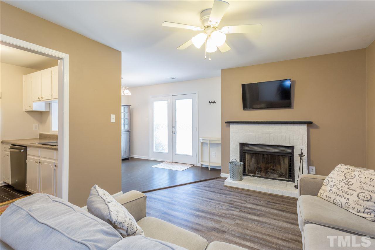 3221 Mill Run Raleigh, NC 27612 - Photo 1 of 20 a living room with furniture a fireplace and a flat screen tv