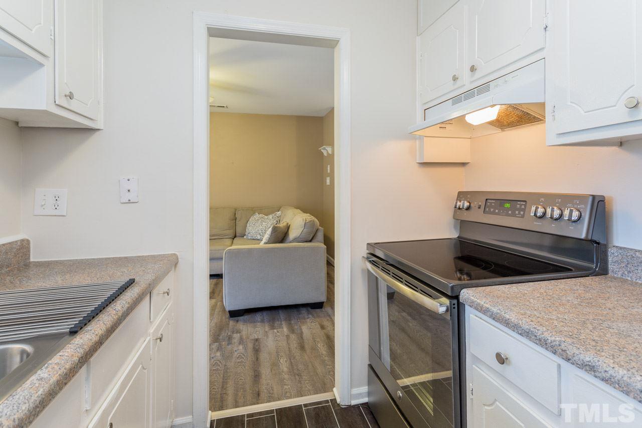 3221 Mill Run Raleigh, NC 27612 - Photo 14 of 20 a kitchen with granite countertop a stove and a sink