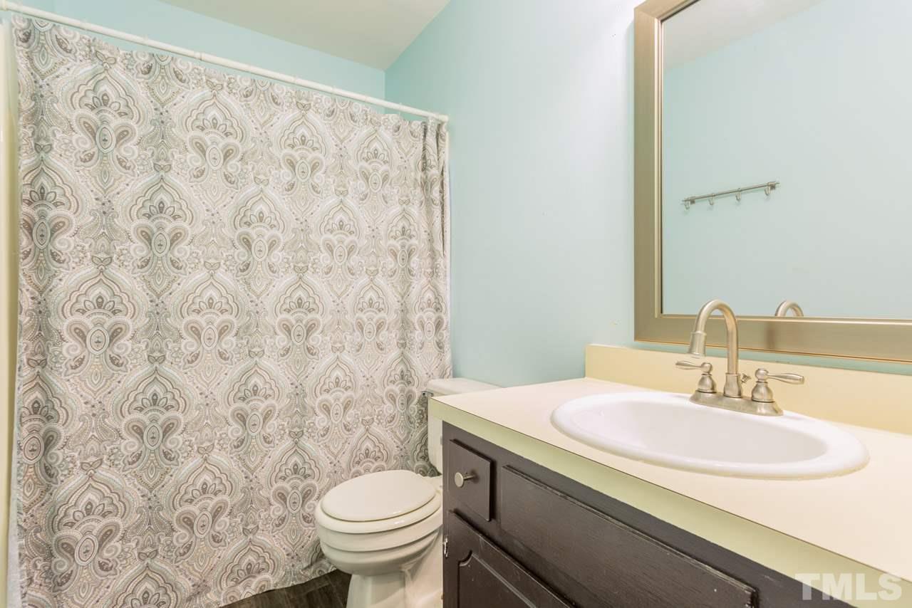 3221 Mill Run Raleigh, NC 27612 - Photo 16 of 20 a bathroom with a sink and a toilet