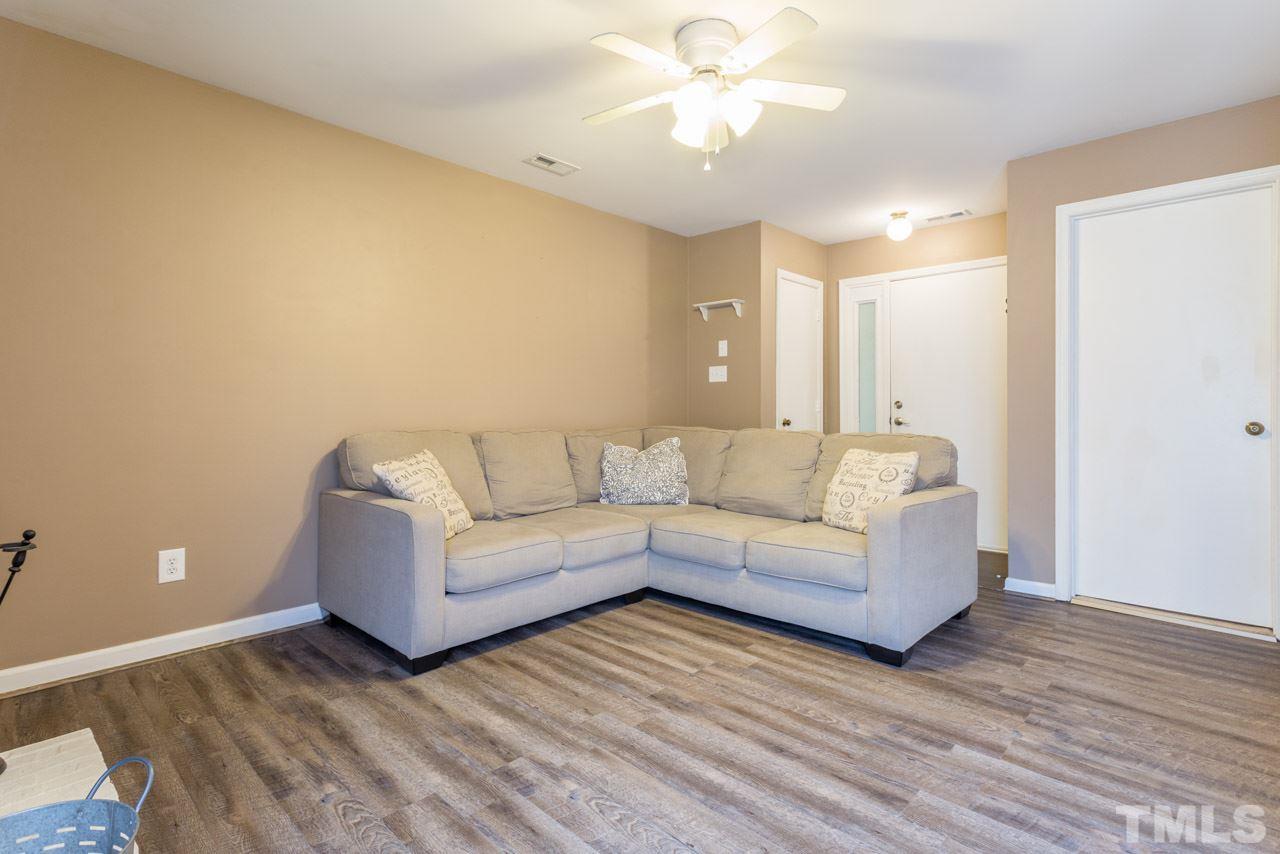 3221 Mill Run Raleigh, NC 27612 - Photo 19 of 20 a living room with couches and potted plant with wooden floor