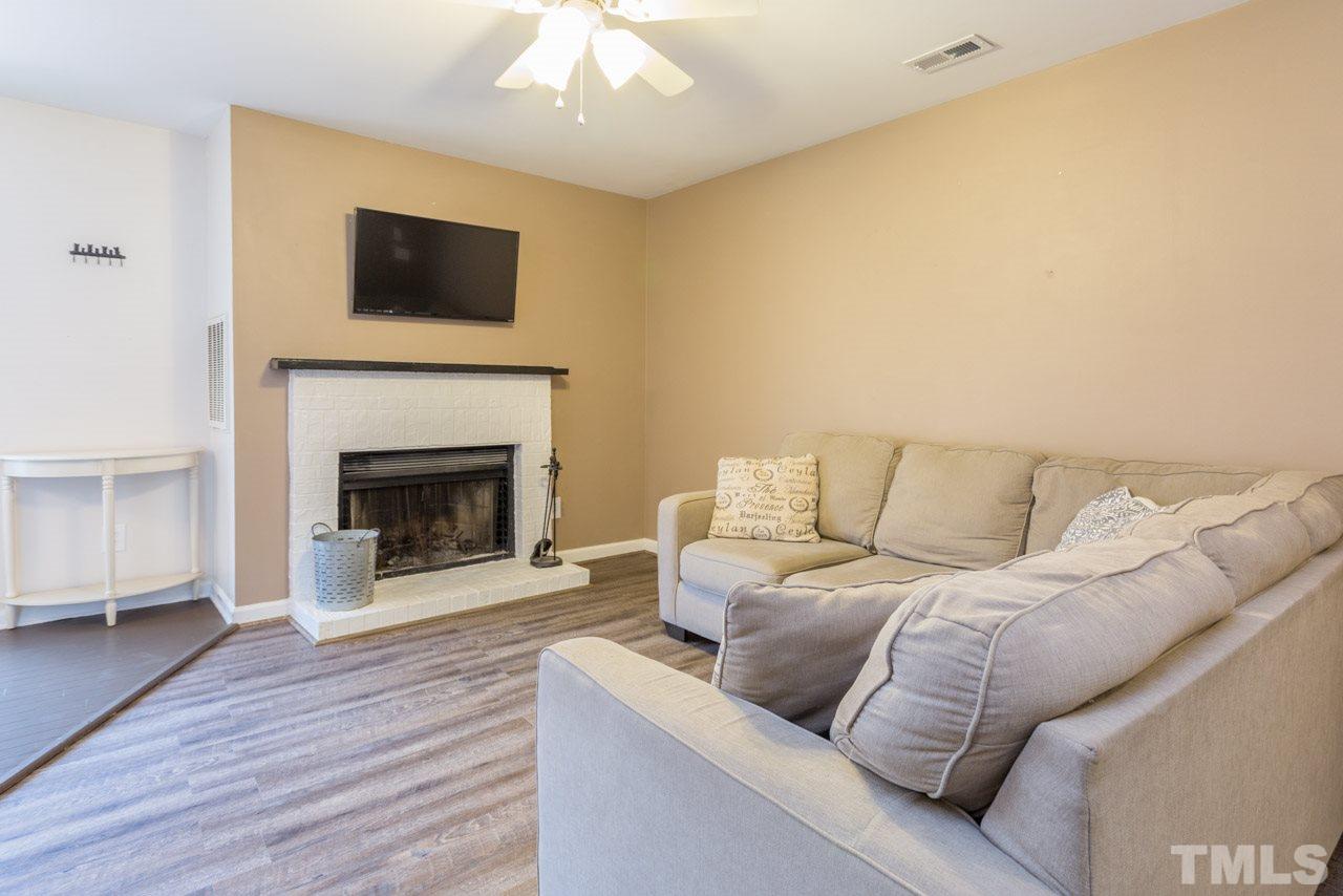 3221 Mill Run Raleigh, NC 27612 - Photo 8 of 20 a living room with a couch and a fireplace