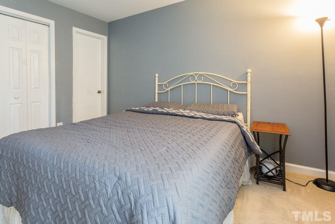 3221 Mill Run Raleigh, NC 27612 - Photo 10 of 20 a bedroom with a bed and chair