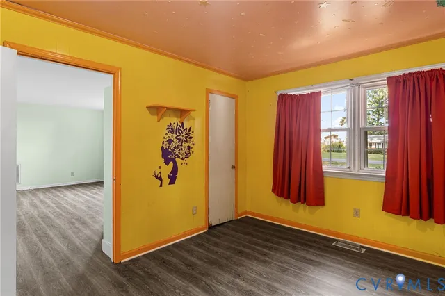 a view of a room with wooden floor and windows