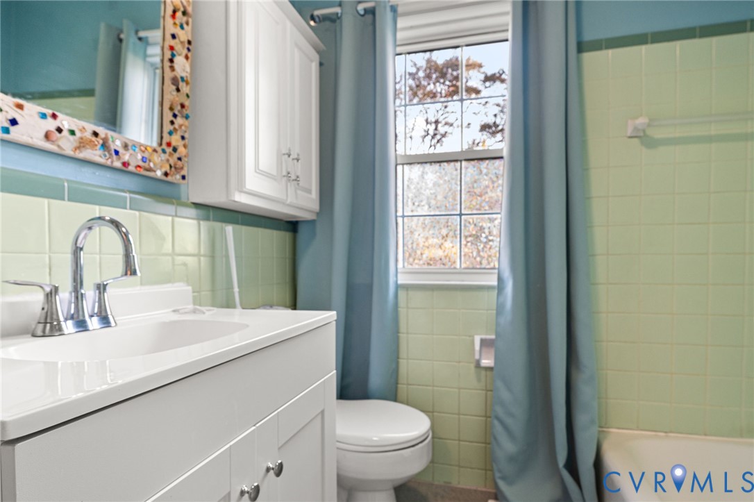 310 East Gwynnfield Road Tappahannock, VA 22560 - Photo 18 of 27 a bathroom with a sink a toilet and a window