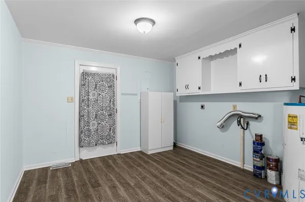 a view of empty room with cabinet and wooden floor