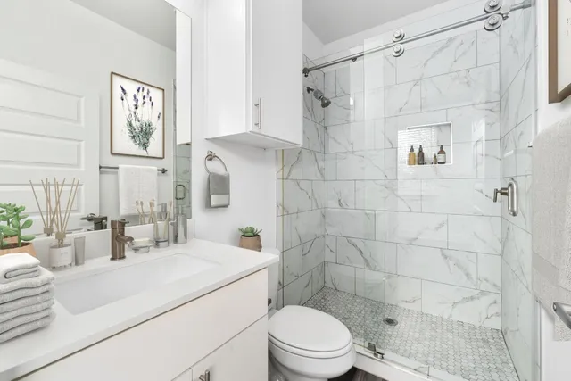 a bathroom with a sink toilet and shower