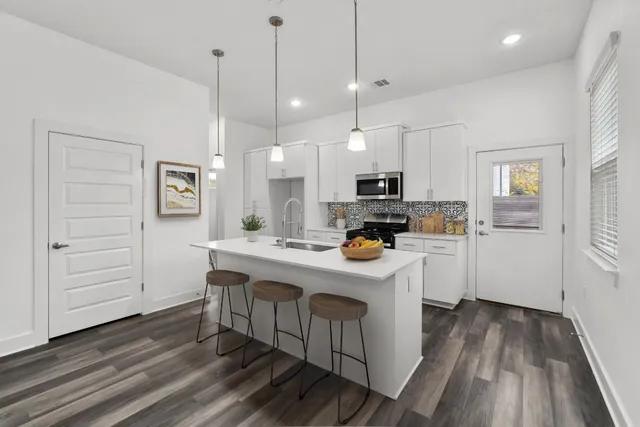 a kitchen with white cabinets and white appliances