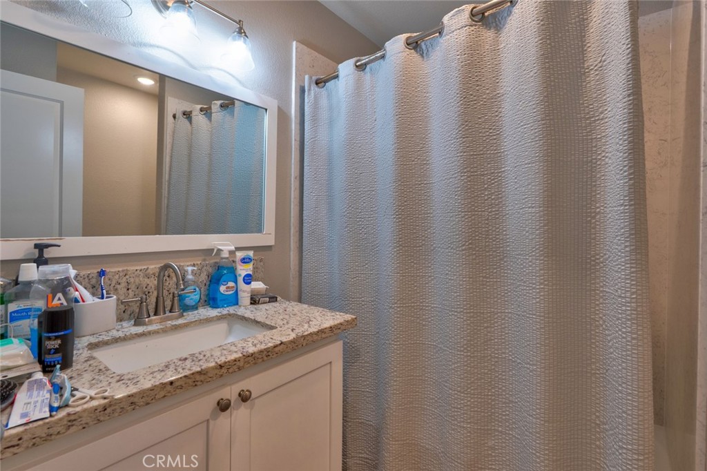 1840 Cheyenne Drive Merced, CA 95348 - Photo 35 of 90 a bathroom with a granite countertop sink and a mirror