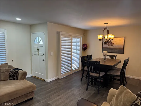 a view of a dining room with furniture and chandelier