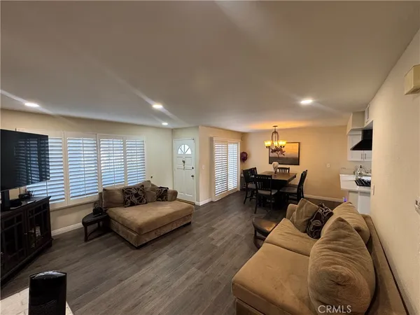 a living room with furniture window and a flat screen tv