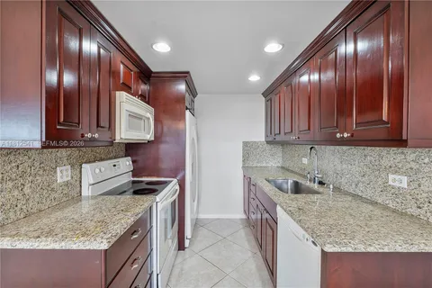 a kitchen with stainless steel appliances granite countertop wooden cabinets a sink and dishwasher