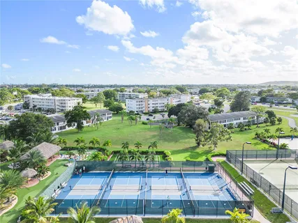 an aerial view of a house with a swimming pool yard and outdoor seating