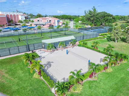 an aerial view of a house with a garden and lake view