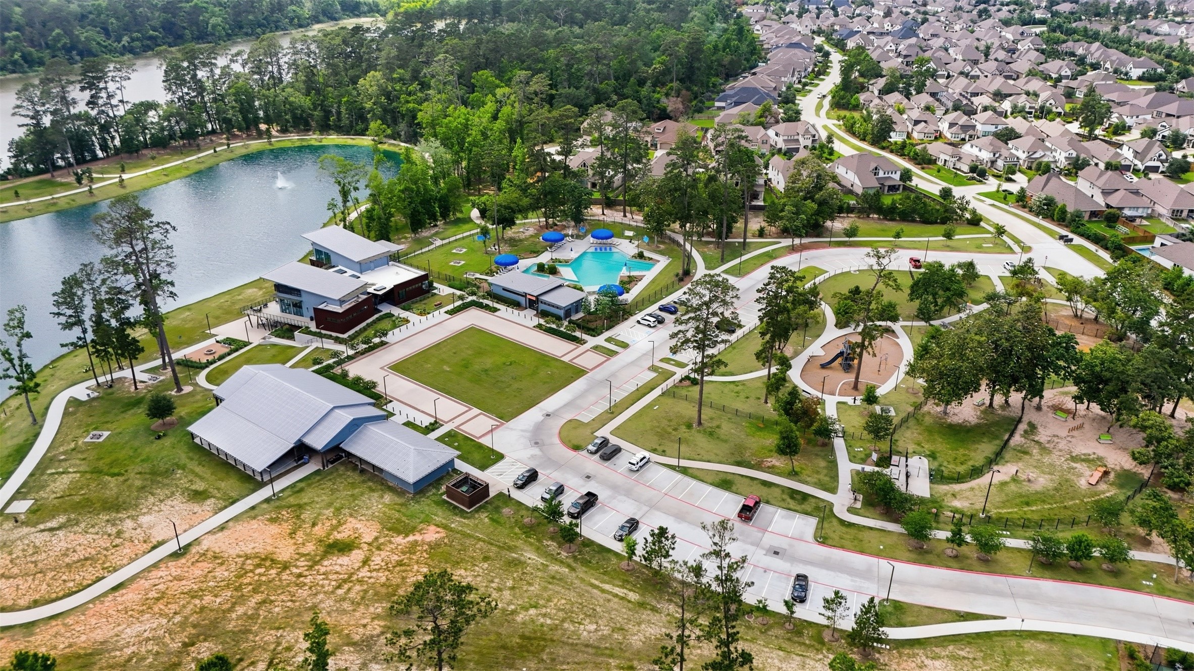 416 Venado View Court Conroe, TX 77304 - Photo 32 of 34 Exceptional community amenities featuring a resort-style pool, clubhouse, green spaces, walking trails, playgrounds, and scenic lakes designed for elevated everyday living.