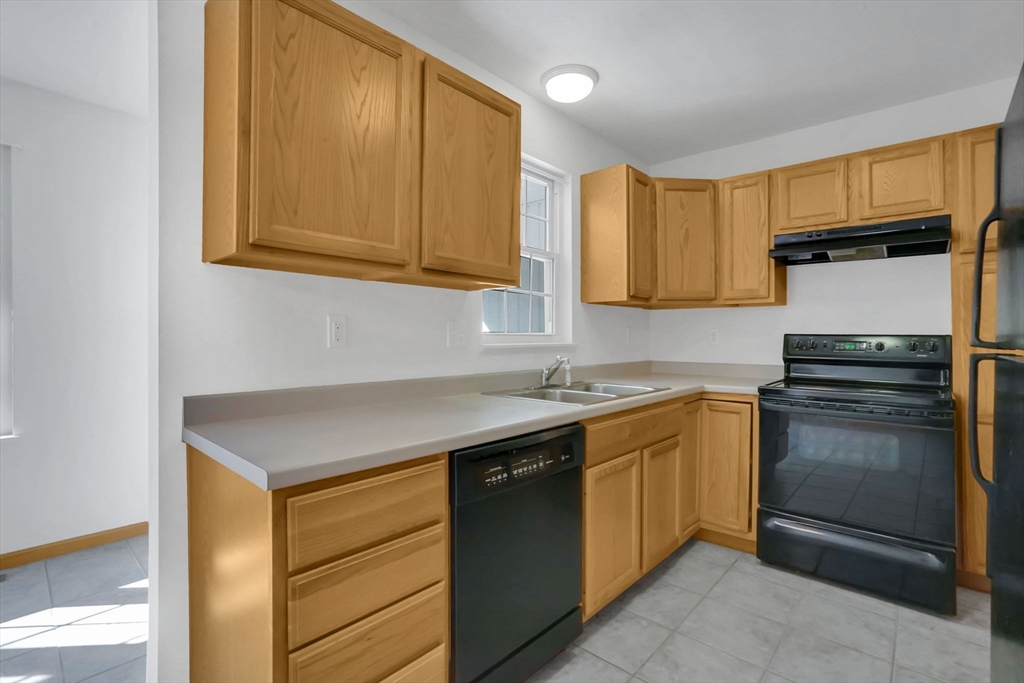 665 Center Street, Unit 705 Ludlow, MA 01056 - Photo 13 of 35 a kitchen with a sink stove and microwave