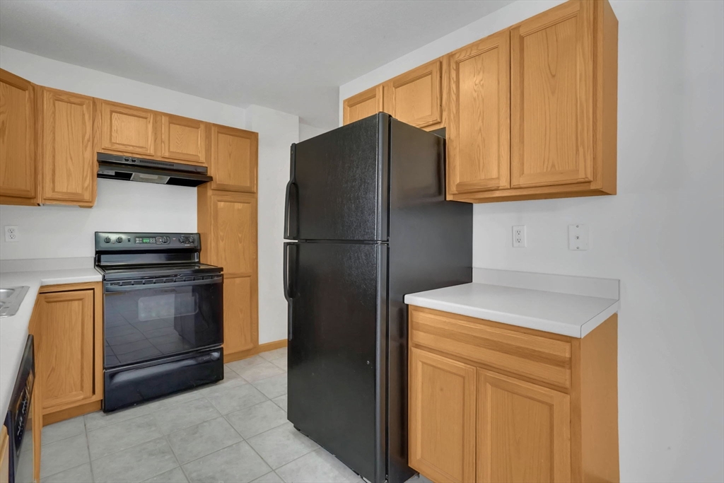 665 Center Street, Unit 705 Ludlow, MA 01056 - Photo 14 of 35 a kitchen with a refrigerator and a stove