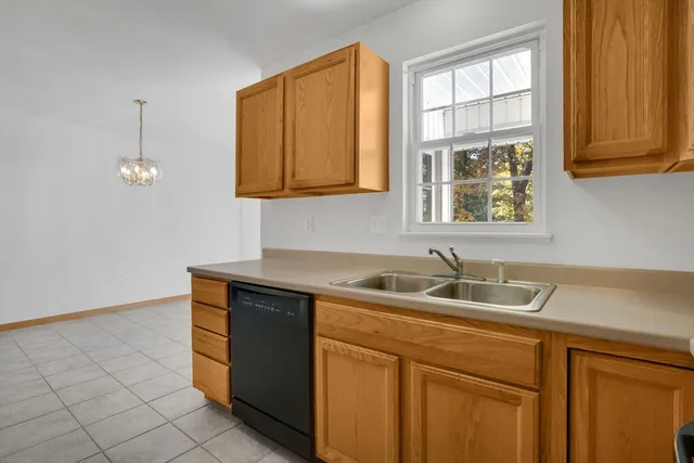 a metallic refrigerator freezer sitting in a kitchen