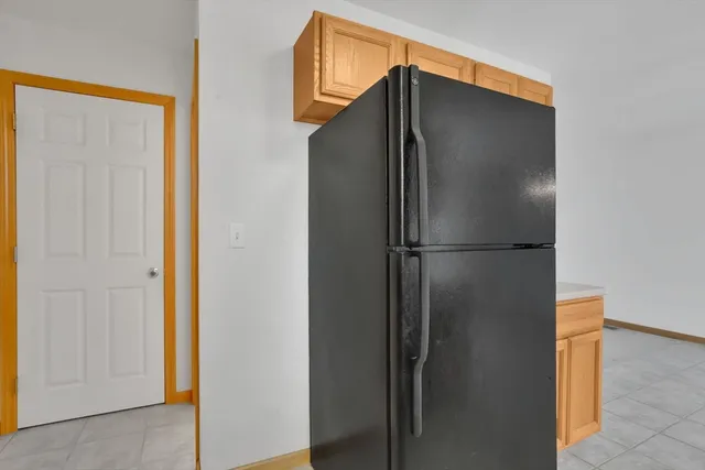 a spacious bedroom with a bed and a flat screen tv