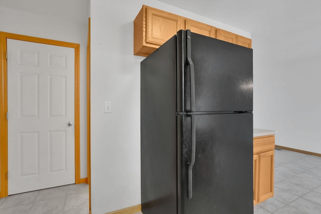 665 Center Street, Unit 705 Ludlow, MA 01056 - Photo 16 of 35 a metallic refrigerator freezer sitting in a kitchen