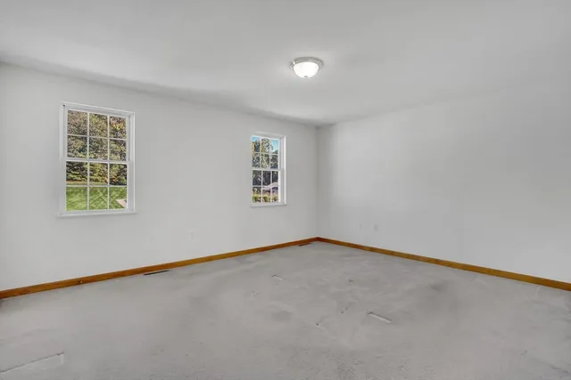 a view of an empty room and a window