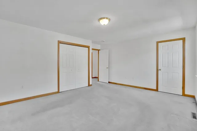 a bedroom with a bed and a potted plant