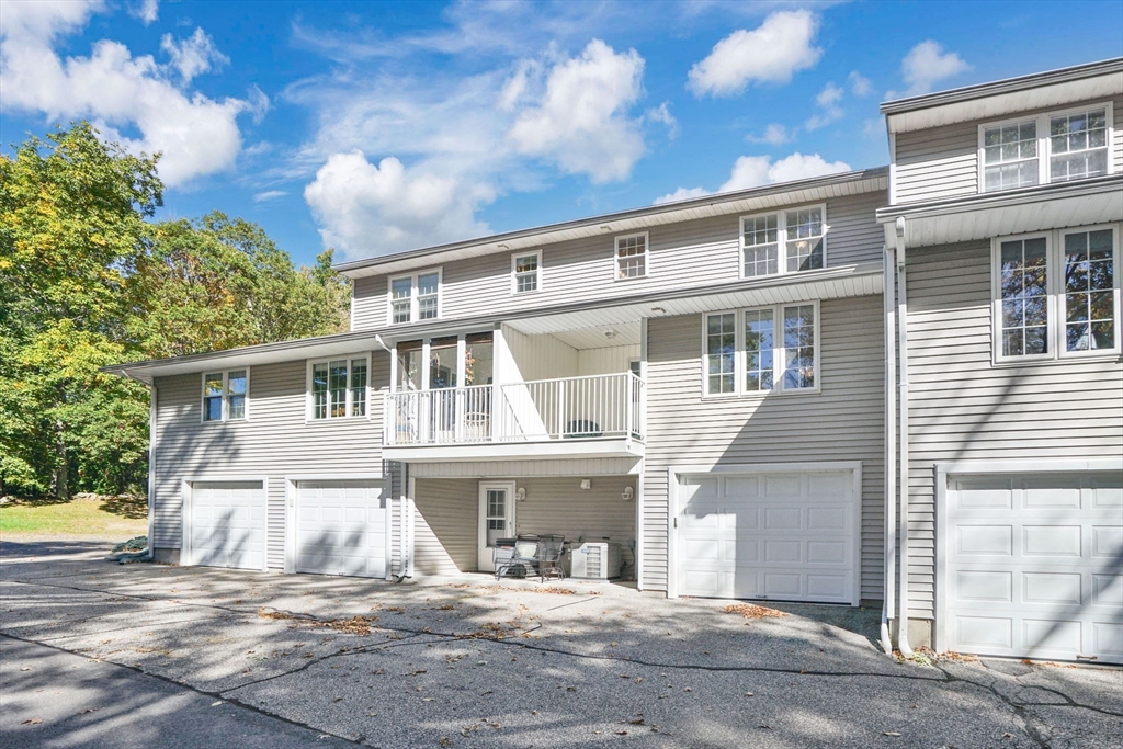 665 Center Street, Unit 705 Ludlow, MA 01056 - Photo 2 of 35 a front view of a house with a garden