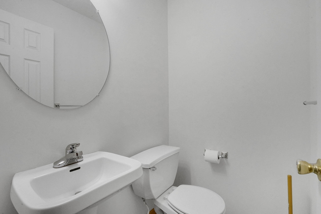 665 Center Street, Unit 705 Ludlow, MA 01056 - Photo 25 of 35 a white toilet sitting next to a white sink
