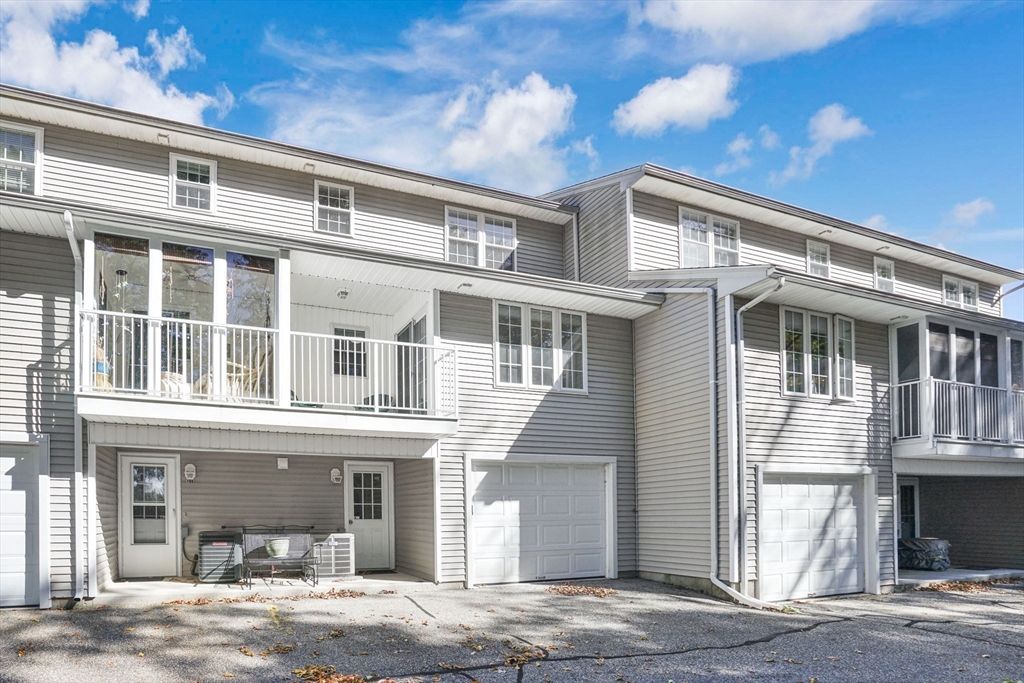 665 Center Street, Unit 705 Ludlow, MA 01056 - Photo 34 of 35 a front view of a building with a garden