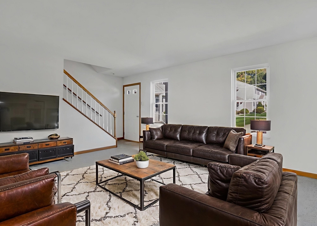 665 Center Street, Unit 705 Ludlow, MA 01056 - Photo 6 of 35 a living room with furniture and a flat screen tv