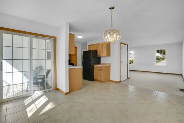 a kitchen with kitchen island granite countertop a stove a sink dishwasher and a refrigerator