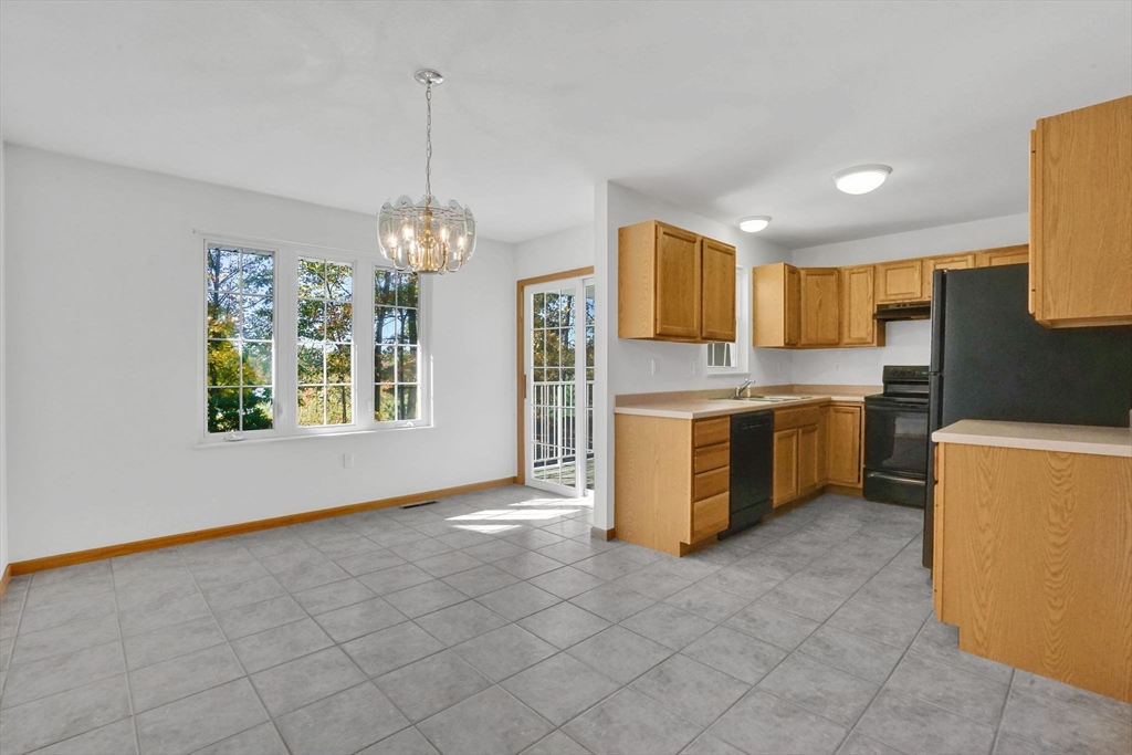 665 Center Street, Unit 705 Ludlow, MA 01056 - Photo 10 of 35 a kitchen with kitchen island granite countertop a stove a sink dishwasher and a refrigerator
