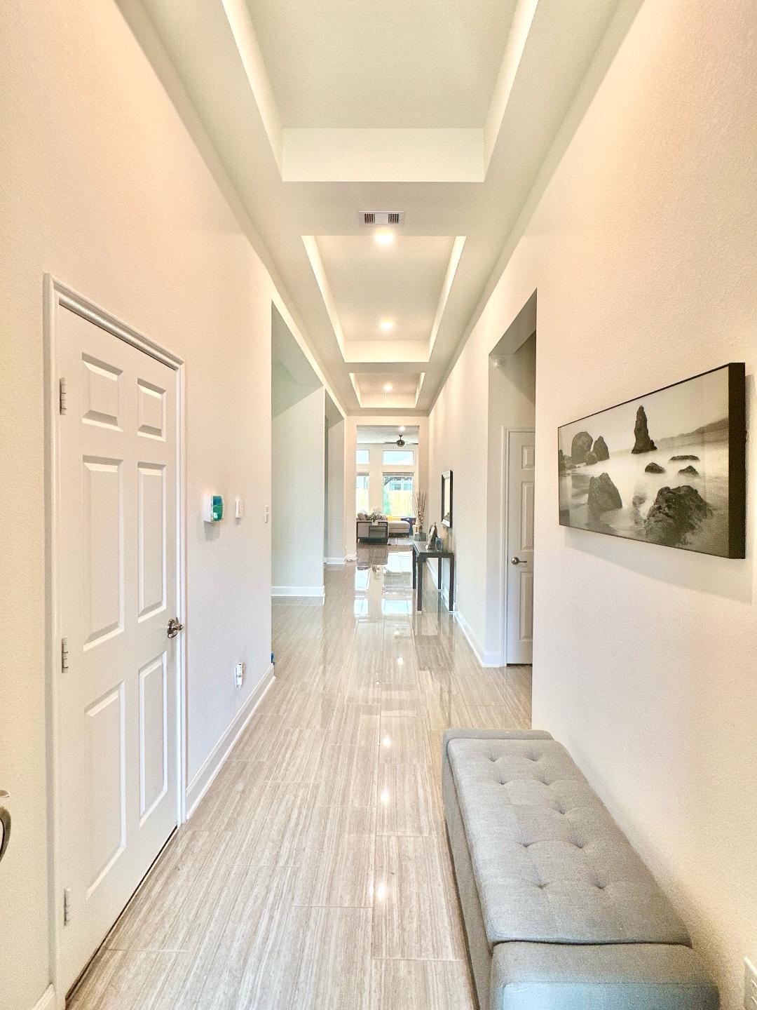 1110 Penny Ranch Lane Katy, TX 77494 - Photo 5 of 31 a view of a hallway with wooden floor and furniture