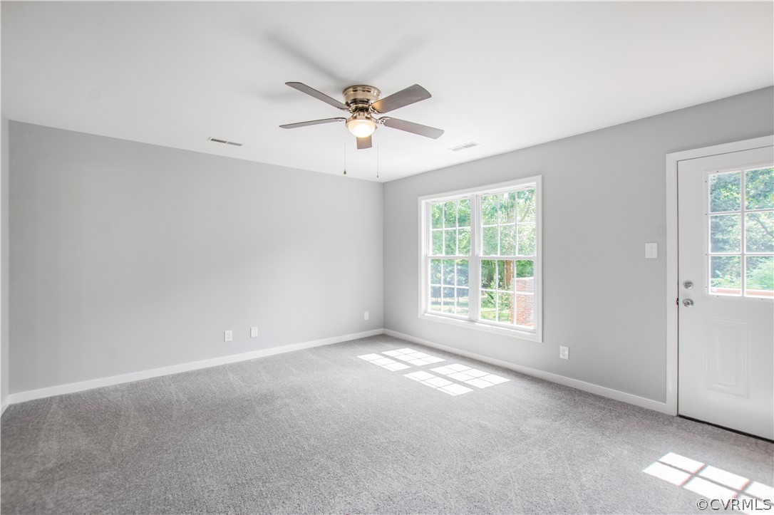 7321 Beach Road Chesterfield, VA 23831 - Photo 12 of 25 a view of a big room with windows and chandelier fan