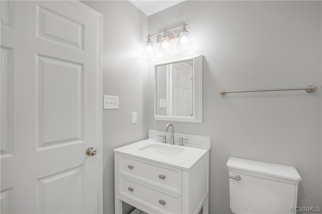 7321 Beach Road Chesterfield, VA 23831 - Photo 15 of 25 a bathroom with a sink a toilet and a mirror