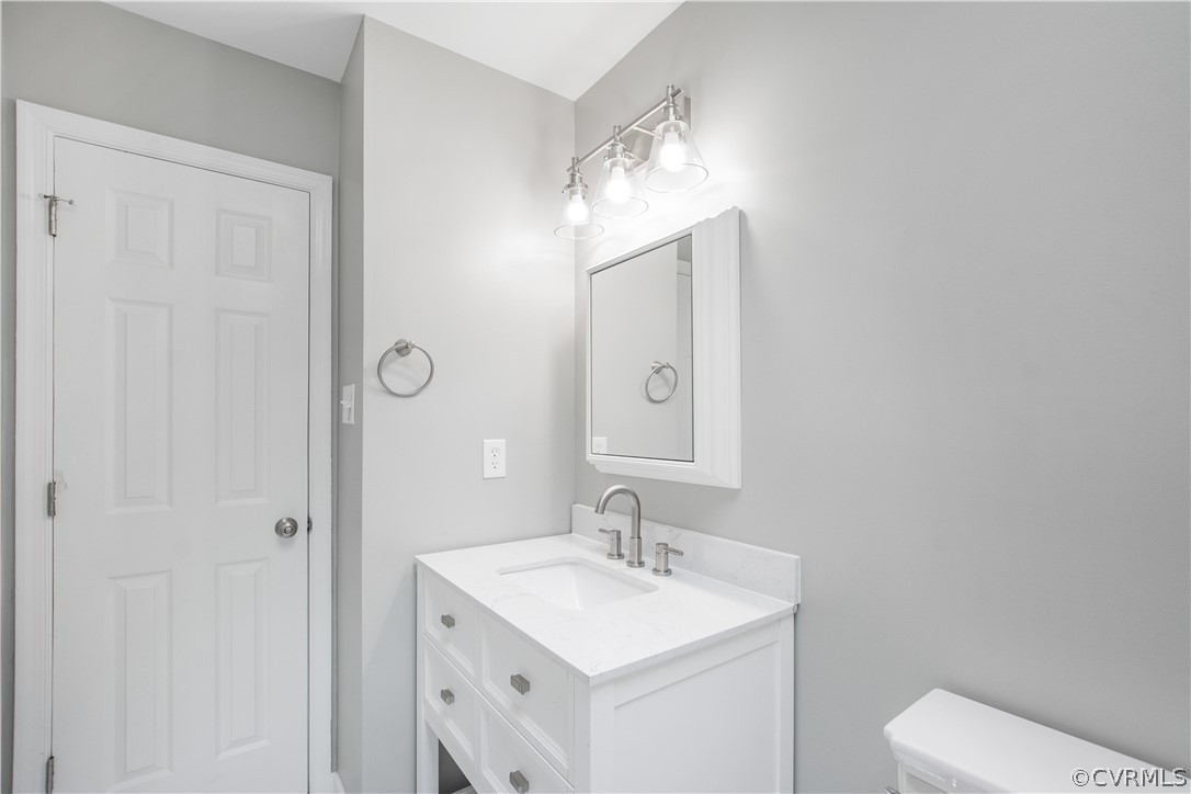 7321 Beach Road Chesterfield, VA 23831 - Photo 19 of 25 a bathroom with a sink a toilet and a mirror