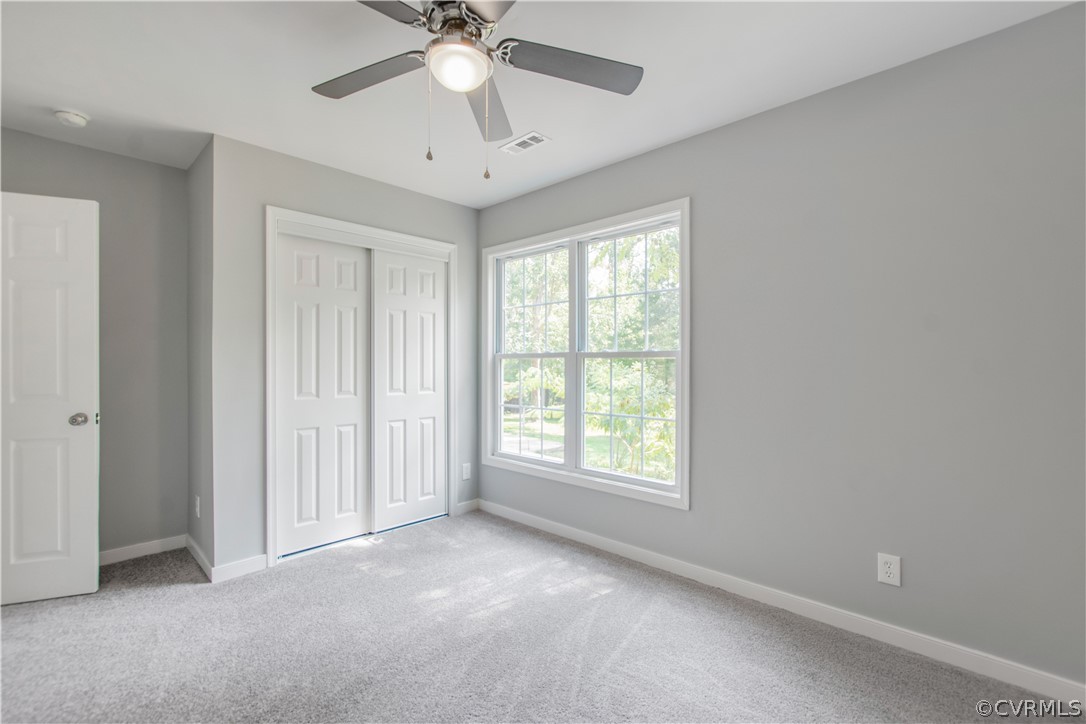 7321 Beach Road Chesterfield, VA 23831 - Photo 21 of 25 an empty room with a window and a fan