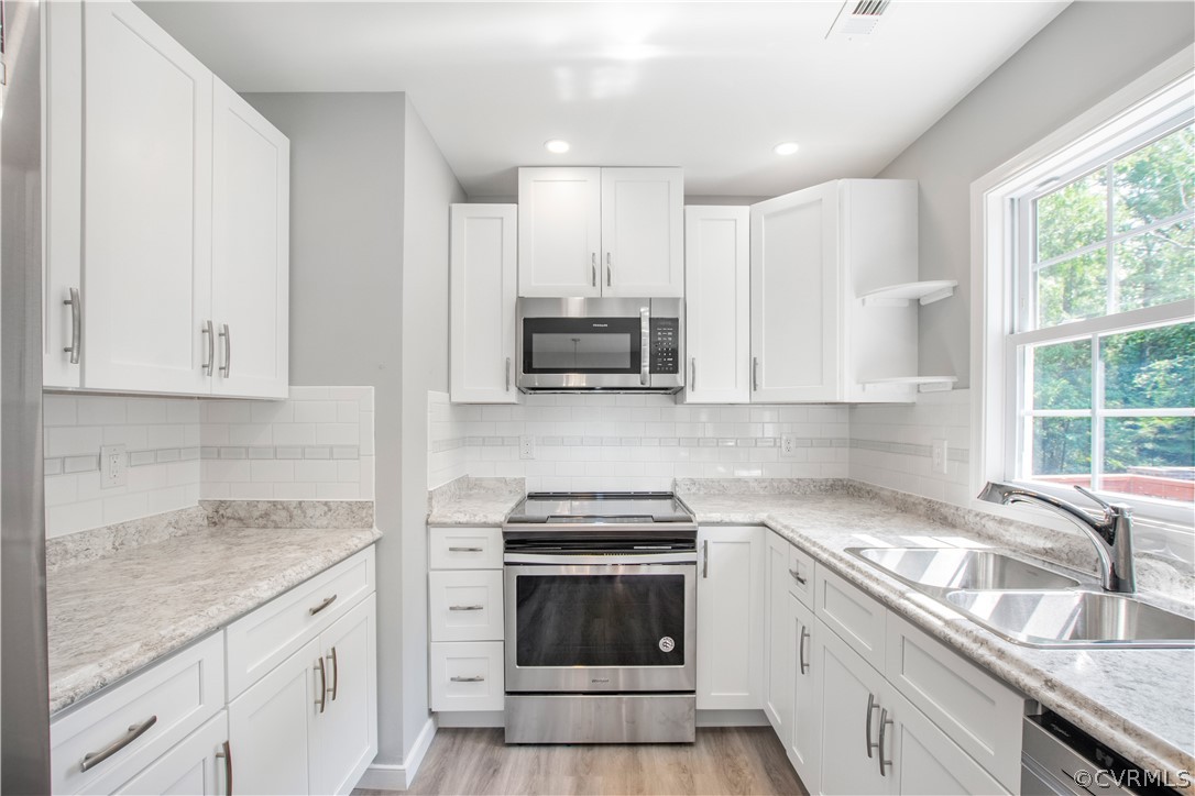 7321 Beach Road Chesterfield, VA 23831 - Photo 7 of 25 a kitchen with granite countertop white cabinets and appliances