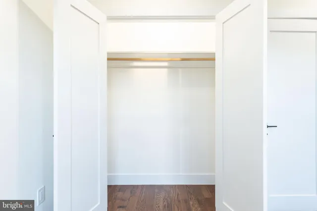 a view of a hallway with wooden floor and entryway