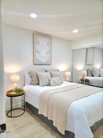 a bedroom with a bed and a lamp