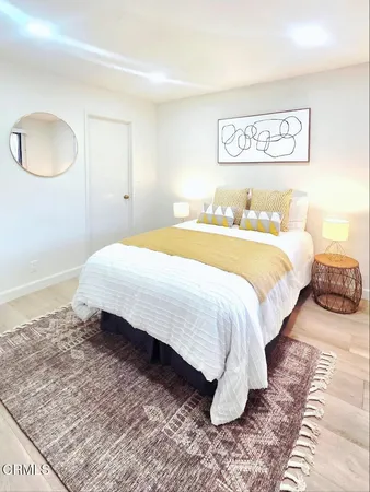 a bedroom with a bed and a couch