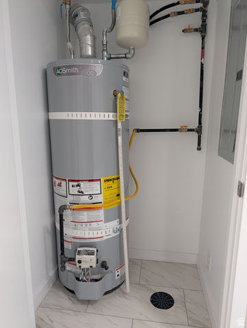 2880 Merton Way Magna, UT 84044 - Photo 13 of 30 Utility closet featuring a water heater unit, associated plumbing, and an expansion tank